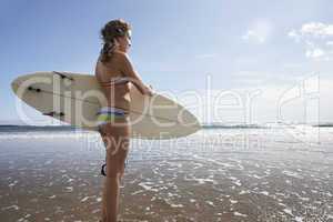 Teenager girl with surfboard