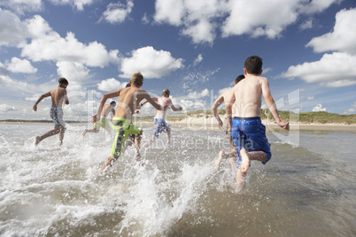 Teenagers playing on beach