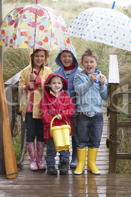 Children posing with umbrella