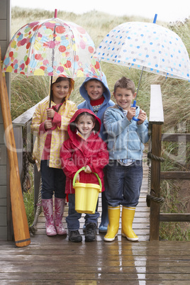 Children posing with umbrella