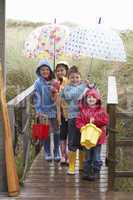 Children posing with umbrella