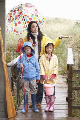 Sad mother and children on beach