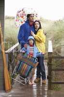 Family on beach with umbrella