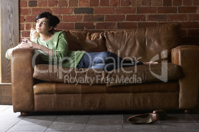 Young woman with phone on sofa