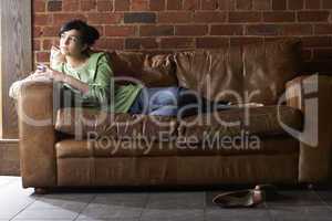 Young woman with phone on sofa