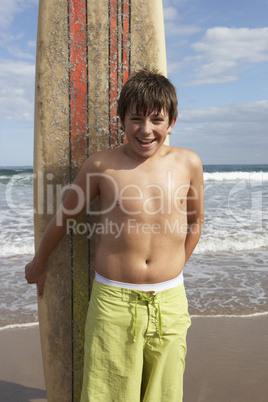 Teenage boy with surfboard