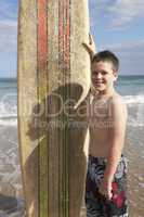 Teenage boy with surfboard