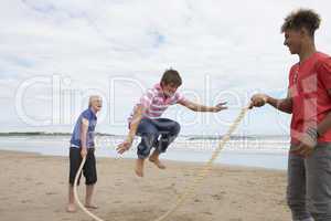 Teenagers playing skipping rope