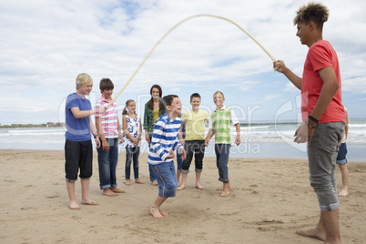 Teenagers playing skipping rope