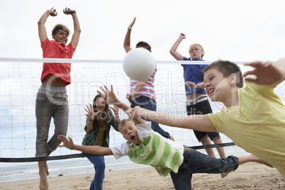 Teenagers playing volleyball