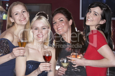 Young women drinking at bar