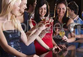 Young women drinking at bar