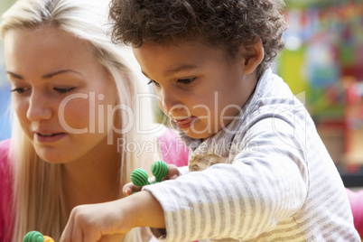 Young woman playing with boy
