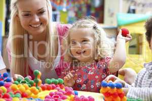 Young woman playing with girl