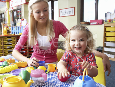Young woman playing with girl