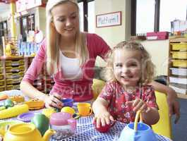 Young woman playing with girl