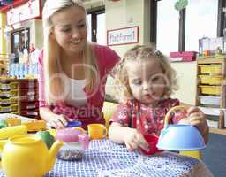 Young woman playing with girl