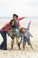 Happy family playing on beach