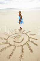 Girl drawing in sand