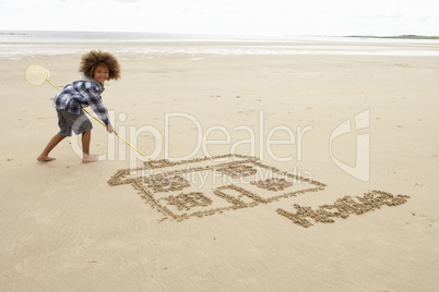 Boy drawing in sand