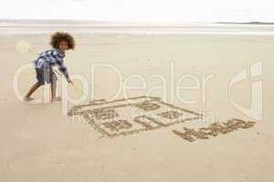 Boy drawing in sand