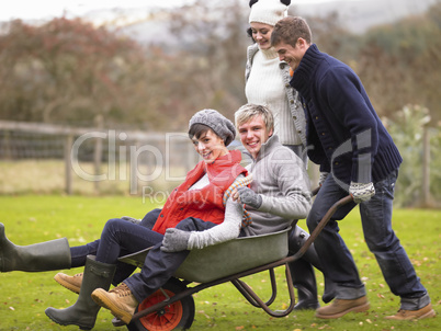 Two young couples playing in wheelbarrow