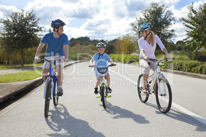 Young Family Parents and Boy Son Cycling