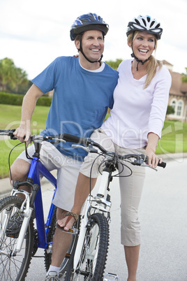 Happy Man & Woman Couple Riding Bikes