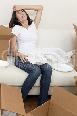 Single Woman Tired Unpacking Boxes Moving House