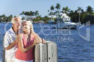Happy Senior Couple By River or Sea with Boat