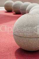 round stones on red ground