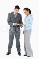 Business partner looking at clipboard against a white background