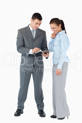 Business partner analyzing documents against a white background