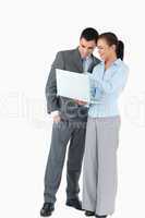 Business partner looking at a laptop against a white background