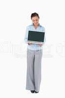Businesswoman showing laptop against a white background