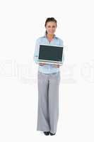 Businesswoman presenting laptop against a white background