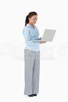 Professional woman working on laptop against a white background