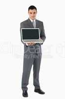 Businessman presenting his laptop against a white background