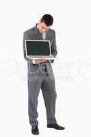 Businessman showing whats on his screen against a white backgrou