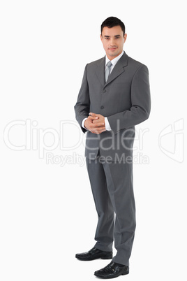 Businessman with hands folded against a white background