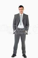 Businessman with his hands in his pockets against a white backgr