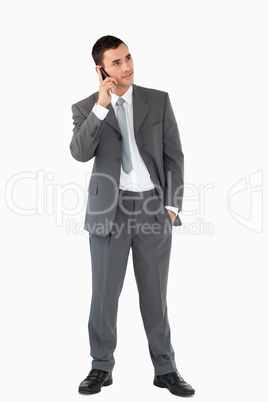 Businessman listening to caller against a white background