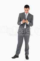 Businessman reading textmessage against a white background