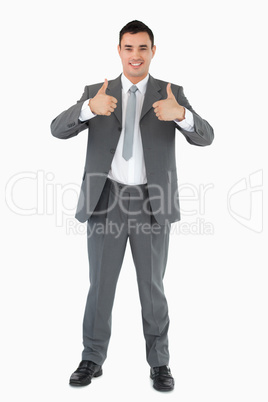 Smiling businessman giving thumbs up