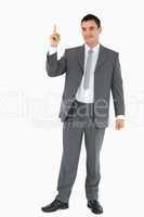 Businessman pointing upwards