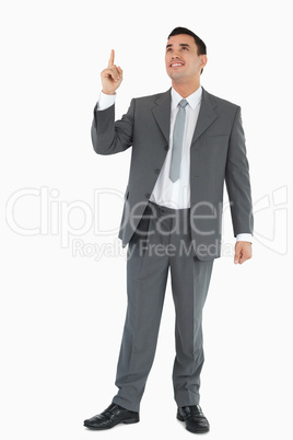 Businessman pointing and looking upwards