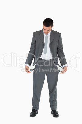 Businessman looking at empty pockets