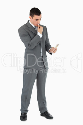 Businessman taking a close look at banknotes