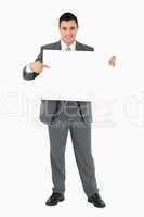 Businessman pointing at sign he is holding