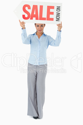 Businesswoman holding sign above her head